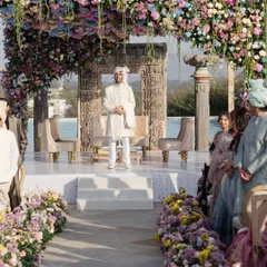 The groom awaits his bride under a stunning floral mandap. I designed this aisle with lush, low floral arrangements in pastel hues to create a beautiful pathway, building anticipation for the bride's grand entrance.