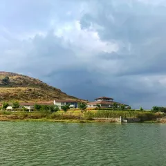 The view from across the lake shows how our retreat is harmoniously integrated with the natural landscape. This is a place where you can feel the calming presence of water and earth all around you.