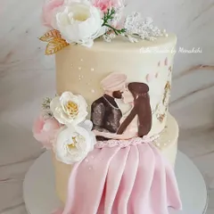 For this engagement cake, I hand-painted a portrait of the lovely Sikh couple, creating a truly personal centerpiece for their celebration. The cake is decorated with delicate sugar flowers and a touch of gold leaf for an elegant finish.