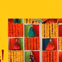 We love adding playful, cultural details to our decor. This unique backdrop features a grid of colorful niches, each filled with either bright marigold garlands or traditional Rajasthani kathputli puppets, adding a whimsical and artistic touch.