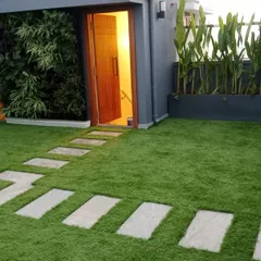 On this rooftop terrace, I combined a full artificial lawn with a stone pathway and integrated it with a vertical garden wall. This demonstrates how synthetic turf can be a key element in a larger, multi-textured landscape design.