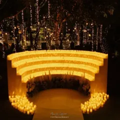 An ethereal entrance for a welcome dinner, where guests walked through an archway bathed in the warm glow of thousands of candles. Our lighting design is focused on creating a magical and immersive ambiance from the very first step.