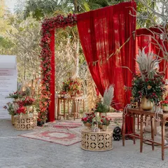 The grand entrance to the wedding, where a lush archway of red florals and dramatic draping set an opulent tone for the ceremony to follow.