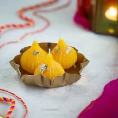 These yellow modak candles are a tribute to festive traditions. I make them from soy wax and add a touch of gold leaf for that extra sparkle.