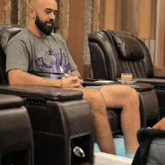 Self care is for everyone. Here, a client unwinds while receiving a professional pedicure in our comfortable, dedicated grooming station. We provide a relaxing environment for men to enjoy essential foot care services.