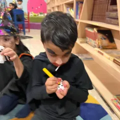 Getting the details just right on his ghost lollipop. The concentration on his face is priceless! Halloween is a great time for imaginative play and spooky crafts.