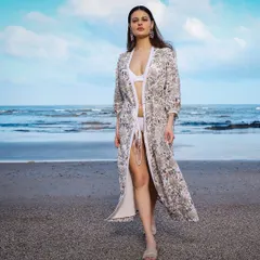 This look was for a resort wear brand's online store shoot. I paired a light, floral embroidered cover-up with a simple white bikini to create an effortlessly chic beach aesthetic that feels both bold and serene.