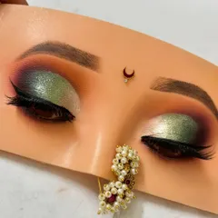 A stunning green and gold half cut crease eyeshadow look. This is a great example of how to play with bold colors for a festive or wedding occasion.