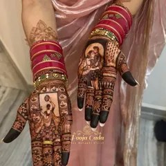 The beauty of a Karwa Chauth design is truly revealed in its rich, dark stain. This photo showcases the stunning color development of a custom portrait mehendi, complete with the bride's festive bangles.