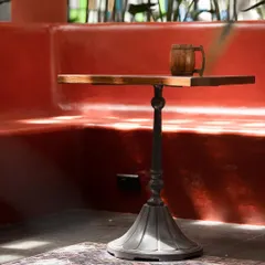 This bespoke table features a solid wood top and a custom-cast metal base. Collaborating with skilled fabricators allows us to design and produce unique furniture that elevates the spaces we create.