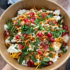 My Samosa Chaat is the ultimate party snack. I break up a crispy samosa and top it with yogurt, chutneys, sev, and fresh pomegranate seeds for a burst of flavor and texture in every bite.