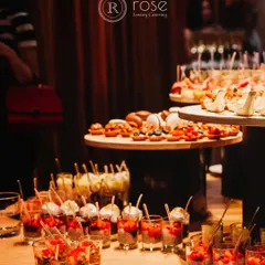 A vibrant spread of appetizers, including dessert cups and savory tarts. This display is perfect for a standing reception, offering guests a variety of sweet and savory options to enjoy while mingling.