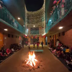 The central courtyard at Ashadeep School transforms into a hearth for the community during the 'Thandd Bhagao' night. This is what I strive for: creating spaces that are not just functional but also serve as the heart of communal life and celebration.