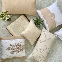 A collection of my beige and white embroidered cushions. Each one features a unique pattern, from intricate floral embroidery to modern geometric stitching, designed to add a touch of effortless elegance to your home.