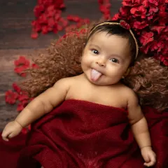 A playful and cheeky moment! It's always a treat when a baby shows off their personality with a little tongue-out expression during a shoot.