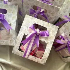 Announcing the arrival of a baby girl with our cute mini hampers. Each bag is filled with sweet treats and tied with a purple ribbon to share the joy.