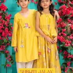 For this brother and sister duo, I designed a custom set in a sunny yellow. His angrakha kurta features delicate bird embroidery, which is mirrored on her beautiful printed lehenga and peplum top.