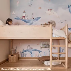 The new wallpaper tells a story with whales, lighthouses, and explorers. The bunk bed is a "flip bed" that can be adjusted as the children grow.