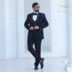 A full-length view of our bespoke navy blue tuxedo. The slim-fit tailoring ensures a modern silhouette, while the detailed handwork provides a touch of classic elegance.