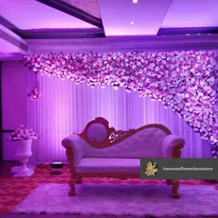 This floral stage setup doubles as a grand photo backdrop. The cascading flower arch and the classic diwan create a royal setting for the main couple's photographs.