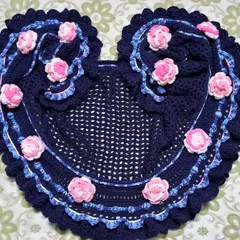 A beautiful heart-shaped piece I created as a pattern tester. Made with navy blue yarn and decorated with delicate pink roses, it can be used as a decorative doily or a small shawl.