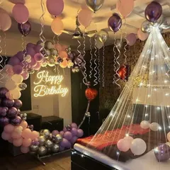Transform any bedroom into a romantic birthday retreat. This surprise decoration includes a beautiful balloon half-arch, ceiling balloons with ribbons, a glowing neon sign, and a fairy light canopy over the bed for a magical atmosphere.