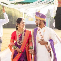 Walking into their forever. This couple looks picture perfect, with the bride's classic makeup and Paithani saree creating a timeless and elegant wedding day look.