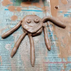 This whimsical clay spider, with its big eyes and friendly smile, is a perfect example of the imaginative creatures that come to life in our kids' workshops.