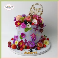 A garden in full bloom, this cake is a feast for the eyes. The lavender-hued cake is lavishly decorated with a cascade of fresh berries, edible butterflies, macarons, and vibrant, beautiful flowers.