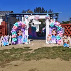 A whimsical entrance for an outdoor mermaid party, featuring arches decorated with pastel balloons and cutouts of adorable mermaid characters.