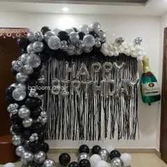 This angle shows the depth of the balloon arch and how it frames the "Happy Birthday" message perfectly for photos.