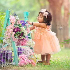 My storytelling setups invite children to interact and play. This image captures a moment of focused curiosity amidst a beautifully styled floral scene.