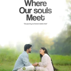 A serene and soulful portrait of a couple sitting in a green field. The text overlay "Where Our Souls Meet" perfectly captures the mood of the image, which is all about deep connection and the start of a shared journey.