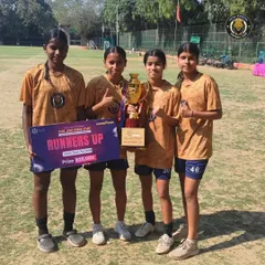 Four of our players holding the runners-up trophy and prize from the JMF Pink Cup. A proud moment reflecting their hard work and team effort.