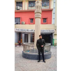 Standing before the emblem of justice at Tis Hazari District Courts. My presence here is a promise to uphold the law and fight for a fair outcome.