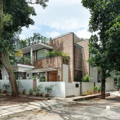 This is the exterior of our Twin Courtyard House. The facade is a composition of natural stone cladding and carefully placed greenery, demonstrating how landscape design can be integral to the architectural identity of a home.