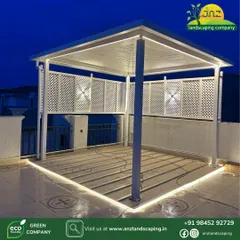 A beautiful white pergola with integrated lighting and decorative lattice panels. This structure creates a private and intimate seating area on a rooftop.