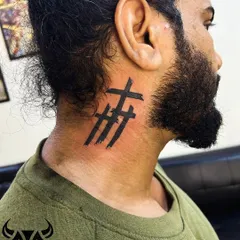 Three crosses in a bold, brush-stroke style on the neck. This design gives a modern and raw feel to a classic symbol.