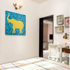 This piece is called "Sun Salutation." The vibrant yellow elephant against a kaleidoscopic blue background is my interpretation of the yoga asana. It's a joyful and energetic piece, perfect for a personal space like a bedroom or study.