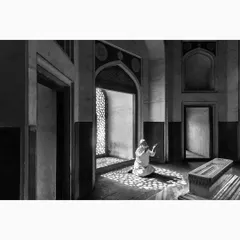 A moment of quiet prayer inside a tomb, where light filters through a jali window, creating a pattern on the floor. This image is about the interplay between light, shadow, and faith. It is a contemplative piece of documentary art that speaks to a universal sense of spirituality.