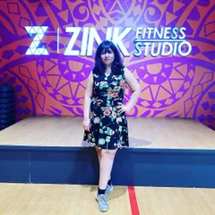 A member posing in front of our signature Zink wall. It's the perfect photo spot to capture that post-workout glow and feeling of accomplishment.