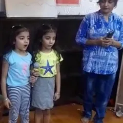 Two young students build their confidence by singing a duet into the microphone during a summer camp activity. We encourage every child to find their voice and express themselves.