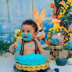 Pure joy and a face full of cake! This little boy is having a blast with his blue birthday cake. Our cake smash sessions are designed to be fun, messy, and absolutely unforgettable.