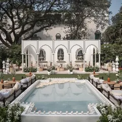 We designed this 'Oasis of Love' by fusing Mughal architecture with a contemporary garden setup, featuring a central reflecting pool for a tranquil and luxurious daytime wedding.