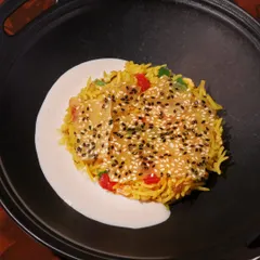 Chawal ka Zarda, a traditional sweet rice dish, layered with a sesame seed crisp and softened by almond milk. A dessert that surprises in every texture.