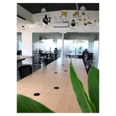An office interior designed for a modern workspace, featuring glass partitions for an open feel and a custom hand-illustrated mural that adds a unique artistic element. The design balances professionalism with creative energy.