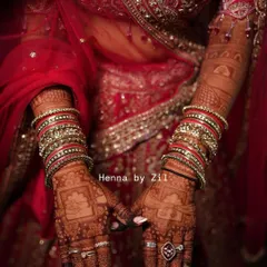 The beauty of a mature henna stain against a rich red bridal lehenga. The color is deep, dark, and absolutely perfect for the big day.