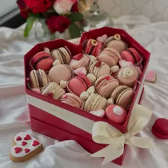 Celebrate love with our luxurious heart-shaped macaron box. It's filled with an assortment of delicate, handcrafted macarons in romantic hues of pink and red.
