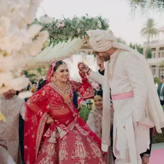 A playful and candid moment during the wedding rituals, capturing the genuine connection and happiness between the bride and groom.
