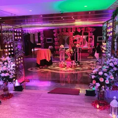 Make a grand entrance that your guests will never forget. For this wedding reception, we designed a spectacular entryway with dramatic lighting, hanging candle installations, and large floral arrangements to set a tone of luxury and celebration from the moment guests arrived.